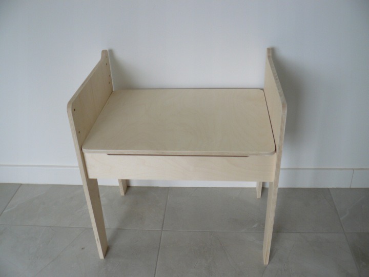 Detský stolík Drewniane Wyroby z lakovanej preglejky má schránku pod doskou a tri polohy pracovnej plochy: 40, 46,5 a 53 cm. Udrží pastelky a drobné pomôcky pri mieste na kreslenie.